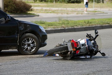 Motorcycle fallen over on street due to accident 